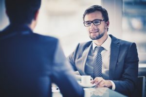 worker-drinking-a-cup-of-coffee-with-a-colleague_1098-3956